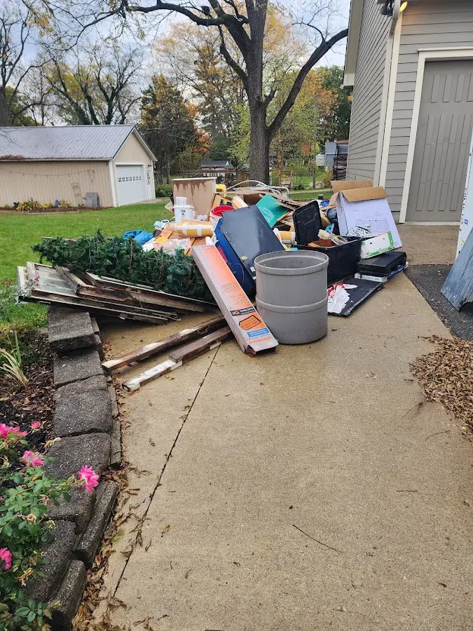 Dumpster being loaded with debris for 10 Yard Dumpster Rental in Ridgeland